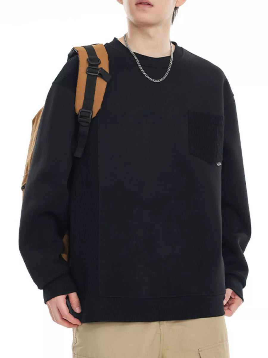 Black crewneck sweatshirt with chest pocket and textured side panel.