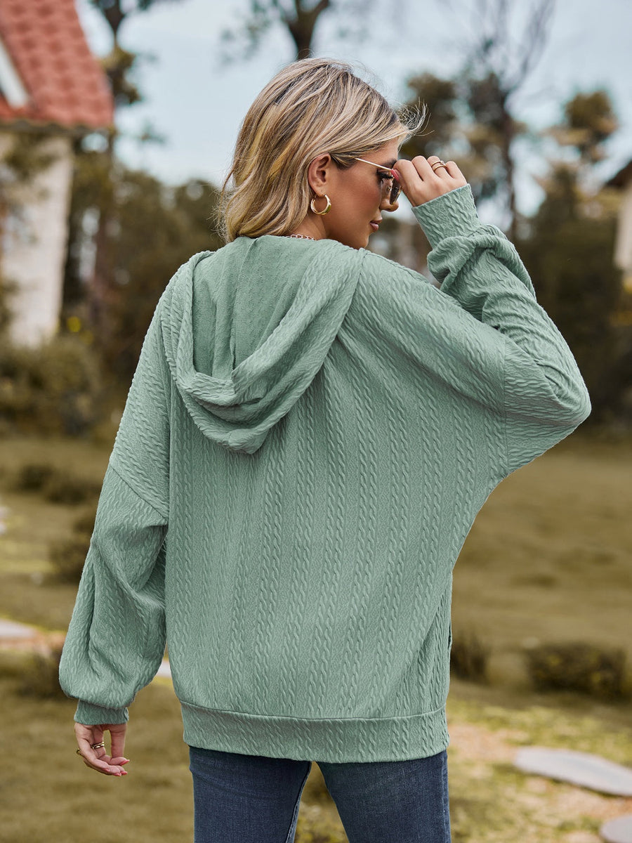Sage green textured knit dolman sleeve hoodie with a hood and cuffed sleeves.