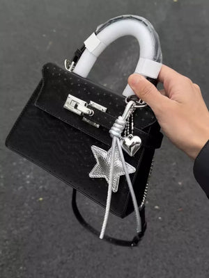 Black embossed mini handbag with star and heart charms