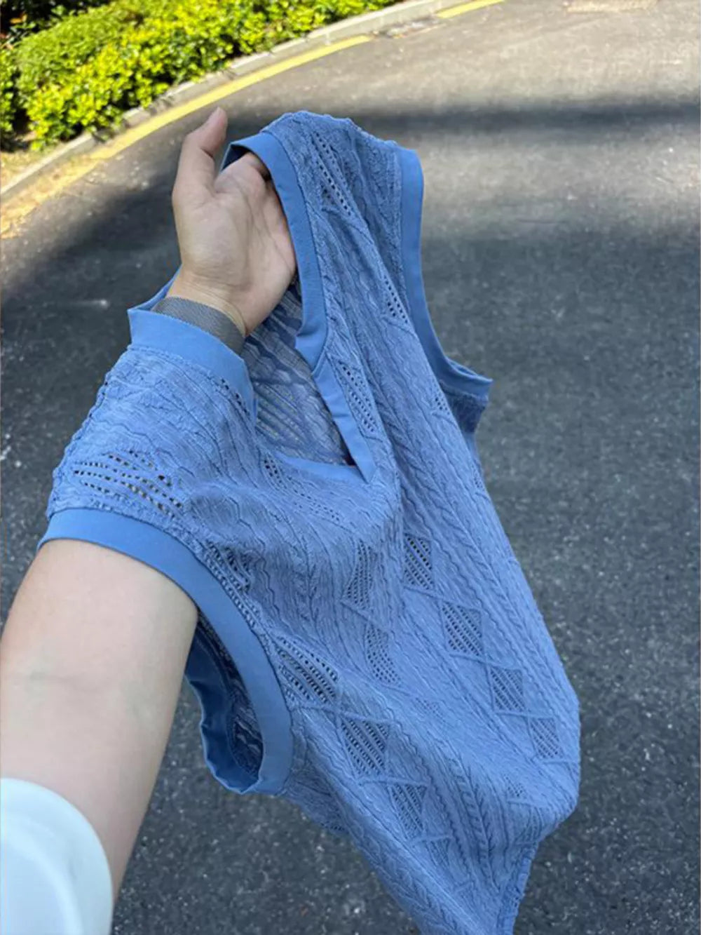 Blue textured knit tank top with relaxed V-neck and diamond pattern detail.