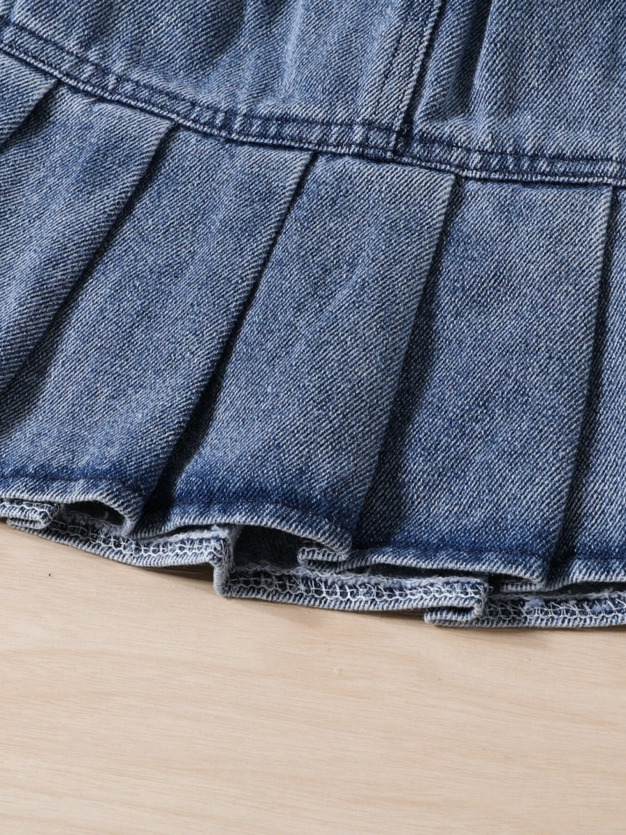 Toddler denim pleated skirt with a frayed hem detail.