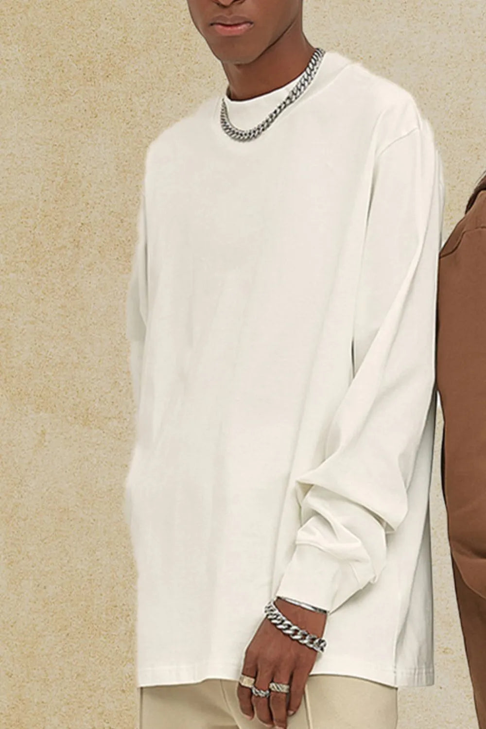 Oversized white crewneck long sleeve t-shirt with a relaxed fit and cuffed sleeves.