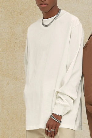 Oversized white crewneck long sleeve t-shirt with a relaxed fit and cuffed sleeves.