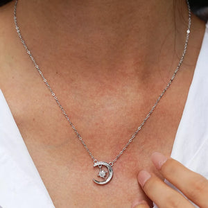 Celestial moissanite crescent necklace with a star charm, delicate silver chain.