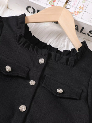 Black ruffle trim top with decorative buttons and pocket details