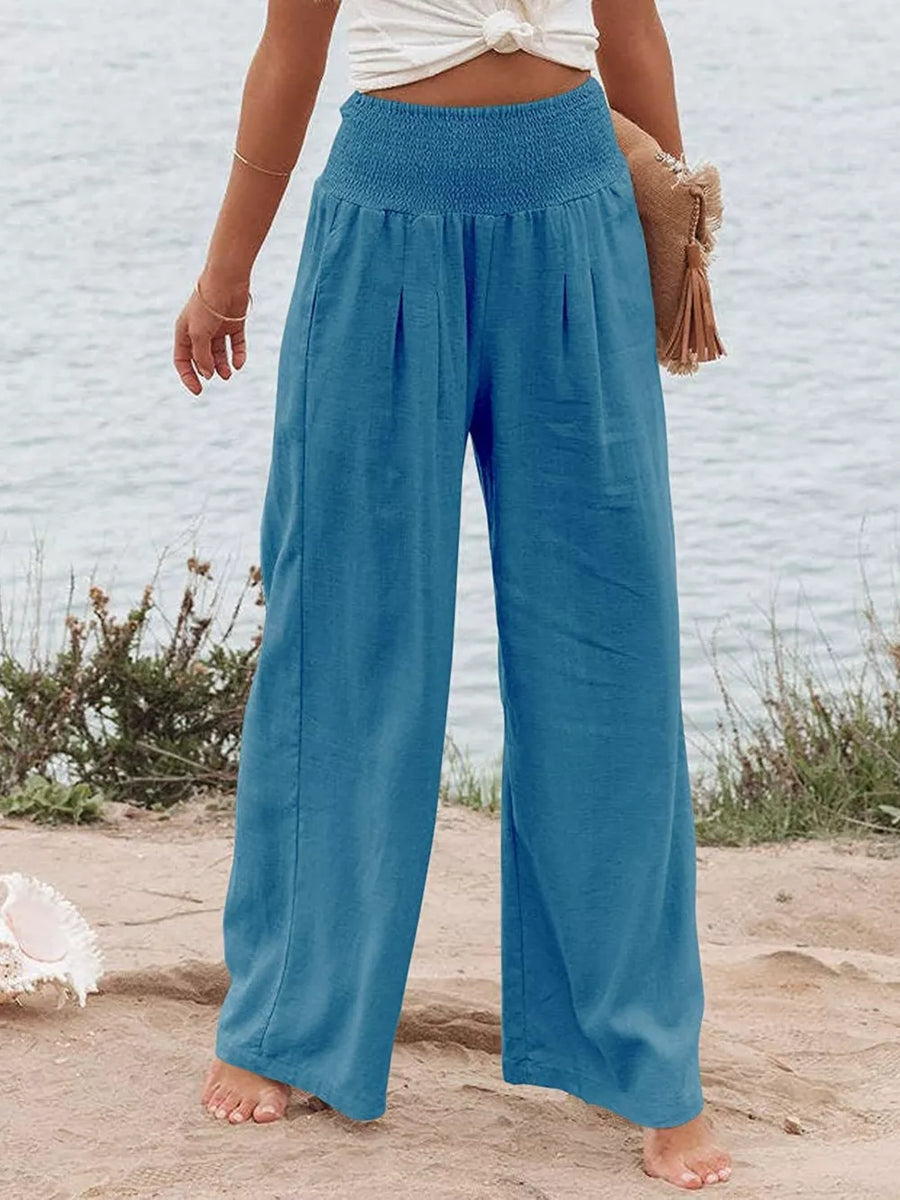 Sky Blue smocked maternity wide-leg pants with pleats and pockets.