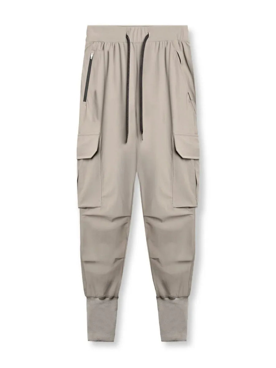 Technical cargo joggers in mocha with ribbed cuffs and zippered pockets.