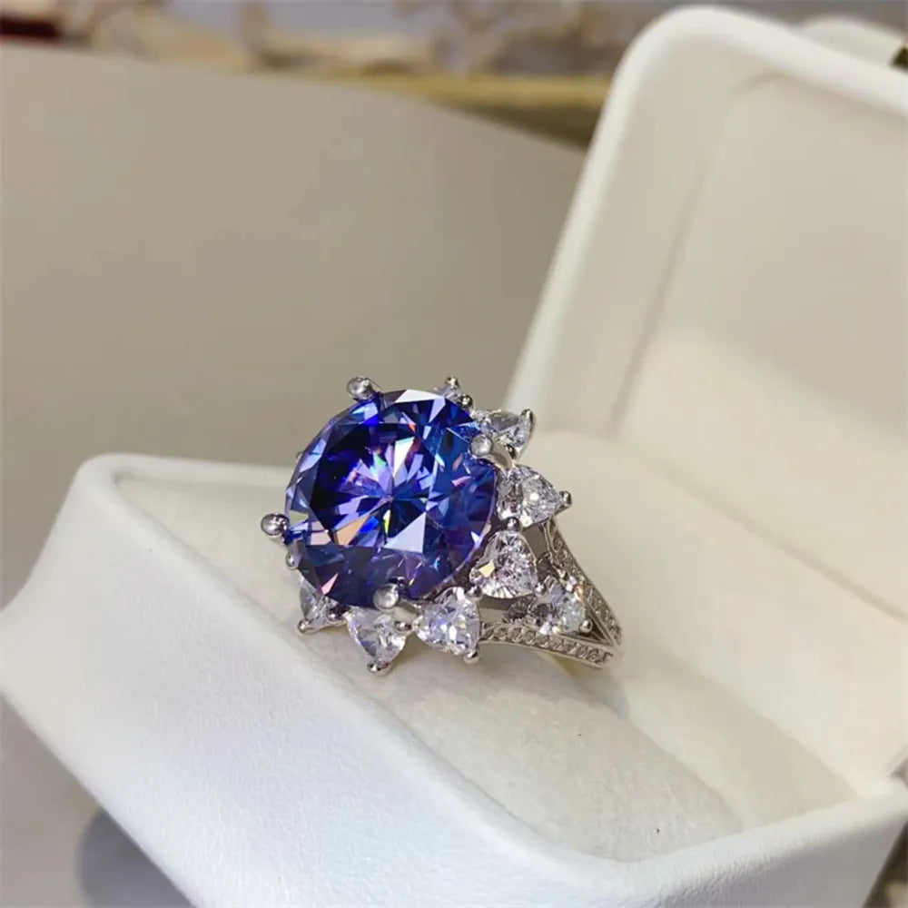 Dark blue moissanite cocktail ring in 925 sterling silver with halo of heart-shaped stones.