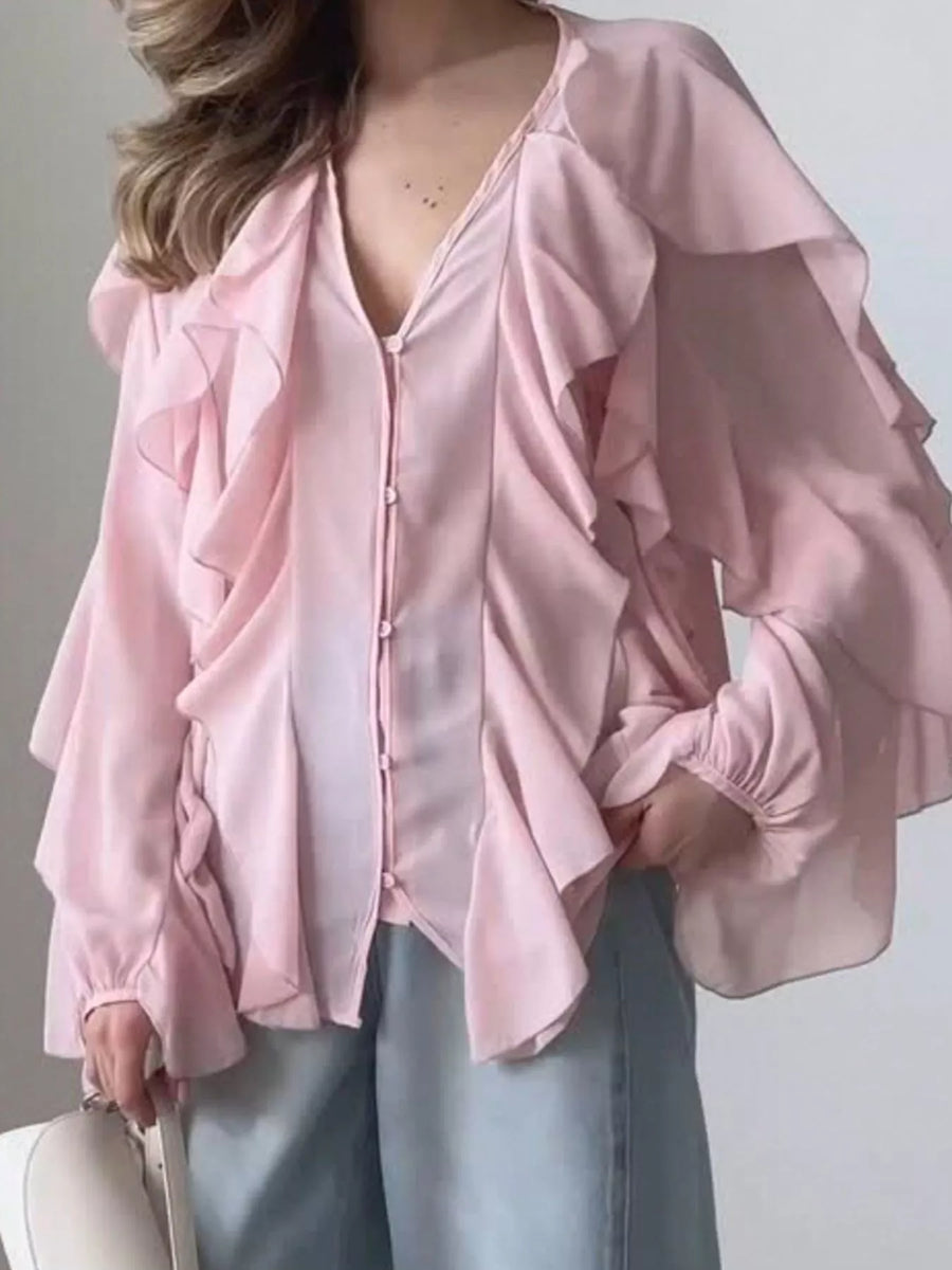 Pink sheer ruffled long-sleeve blouse with button front and V-neckline.