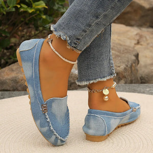 Light denim loafers with stitch detail and metal accent.