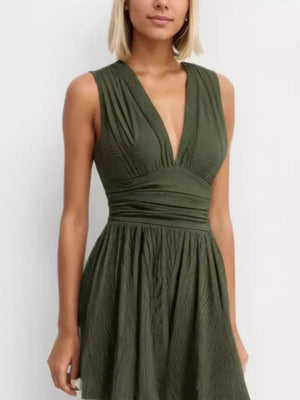 Army green ruched deep V-neck romper with cinched waist and a-line skirt.