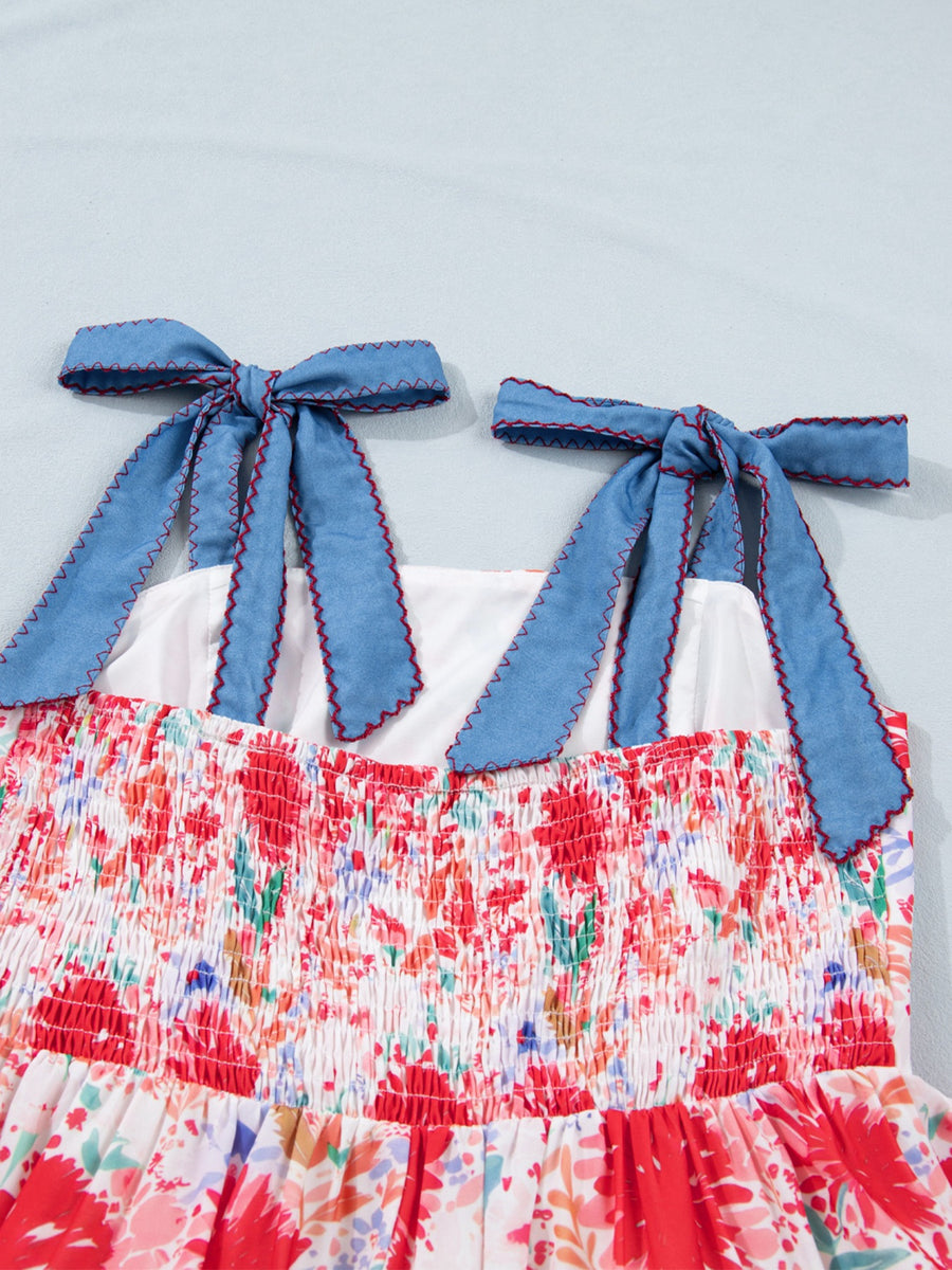 Floral print midi dress with smocked bodice and blue tie-shoulder straps.