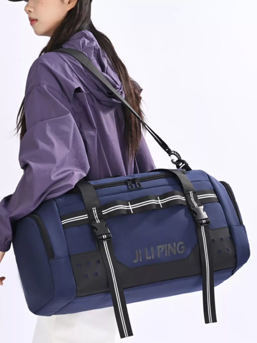 Blue Oxford cloth travel tote bag with black accents and white stripe compression straps