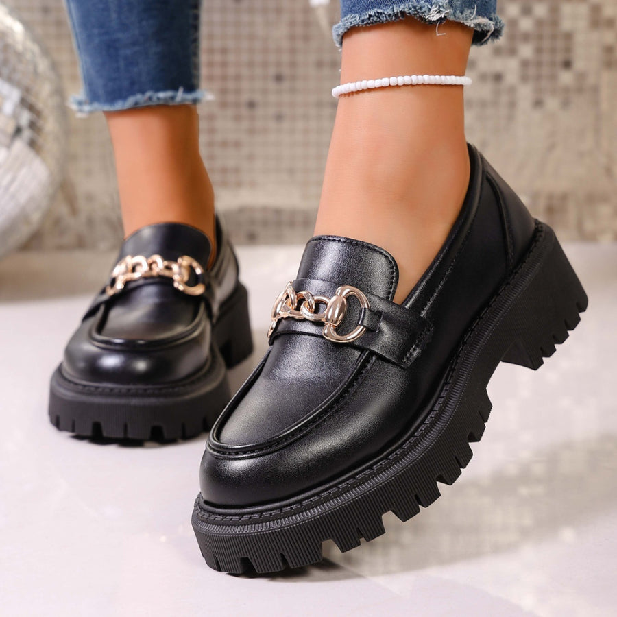 Chunky lug sole loafers in gloss black with gold chain detail and thick platform sole.