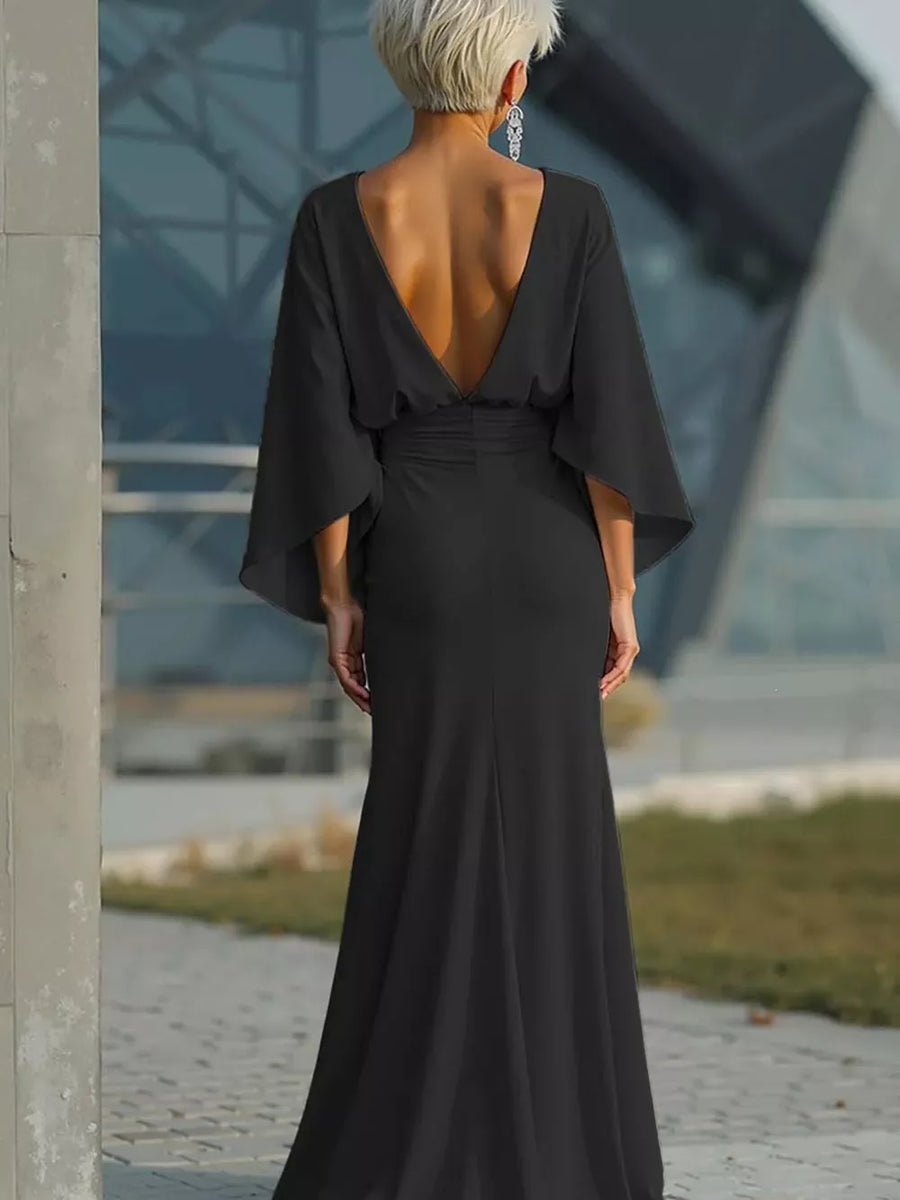 Black batwing sleeve maxi dress with deep V-back and flowing skirt.