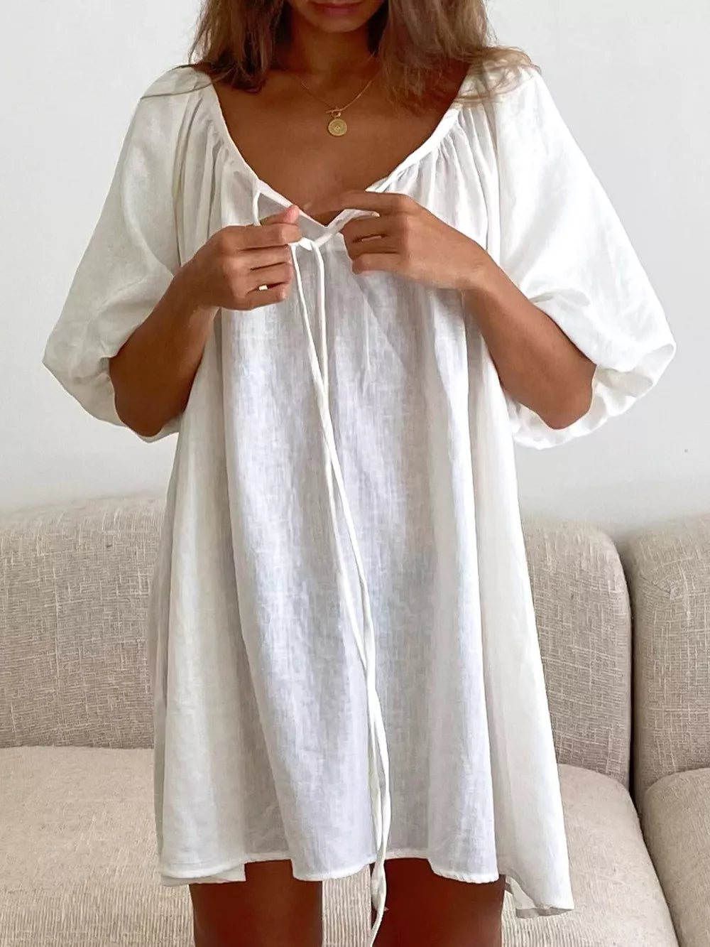 mini dress in ivory featuring puff sleeve and relaxed fit