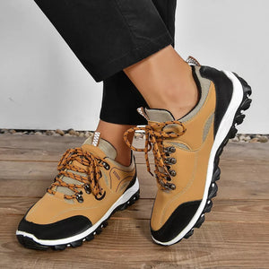 Brown low-top sneakers with patterned laces and black accents