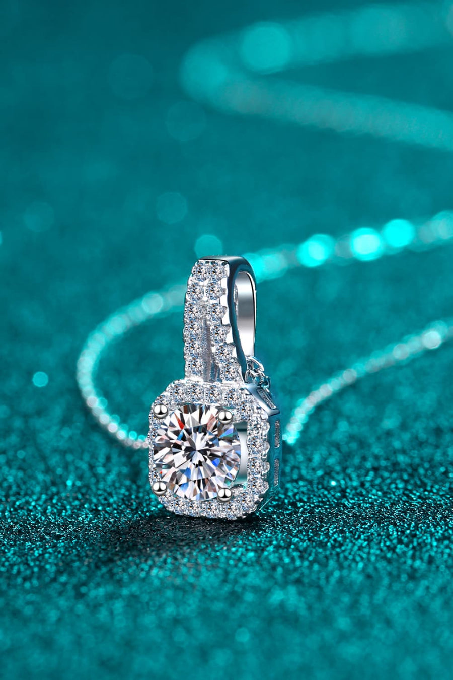 Silver cushion halo moissanite pendant necklace with a delicate chain.