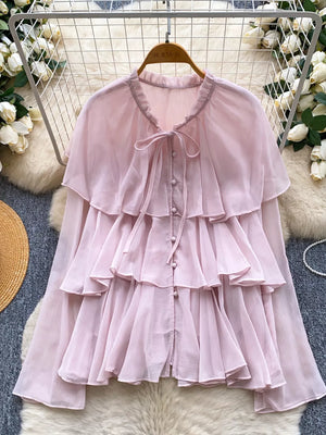 Pink chiffon blouse with tiered ruffles and bow tie neckline