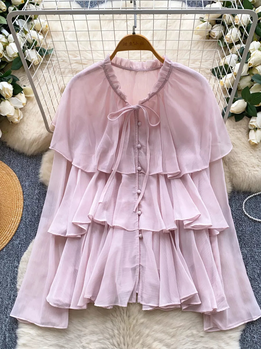 Pink chiffon blouse with tiered ruffles and bow tie neckline