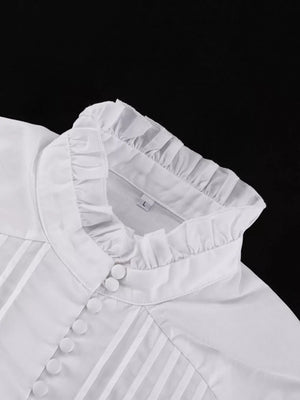 White cotton blouse with ruffled high neck and pintuck details.
