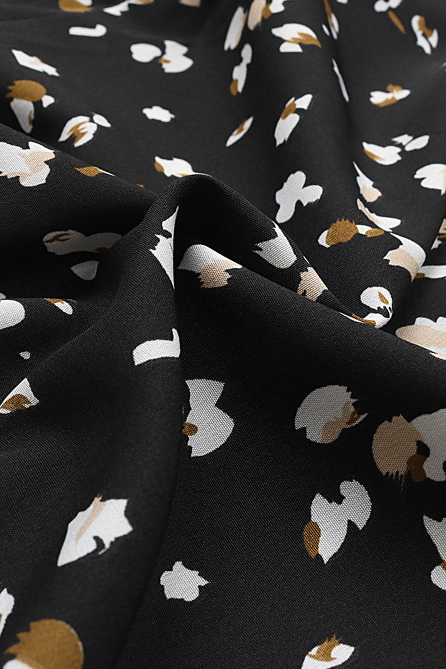 Black midi wrap dress with abstract floral print and button front detail.