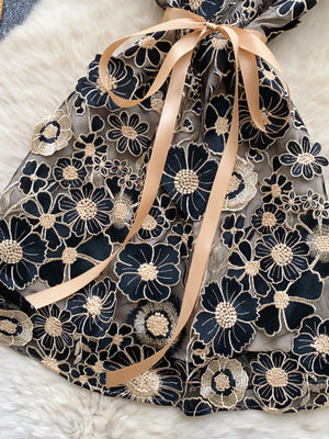 Embroidered floral mini dress in Black Gold with a bow detail.