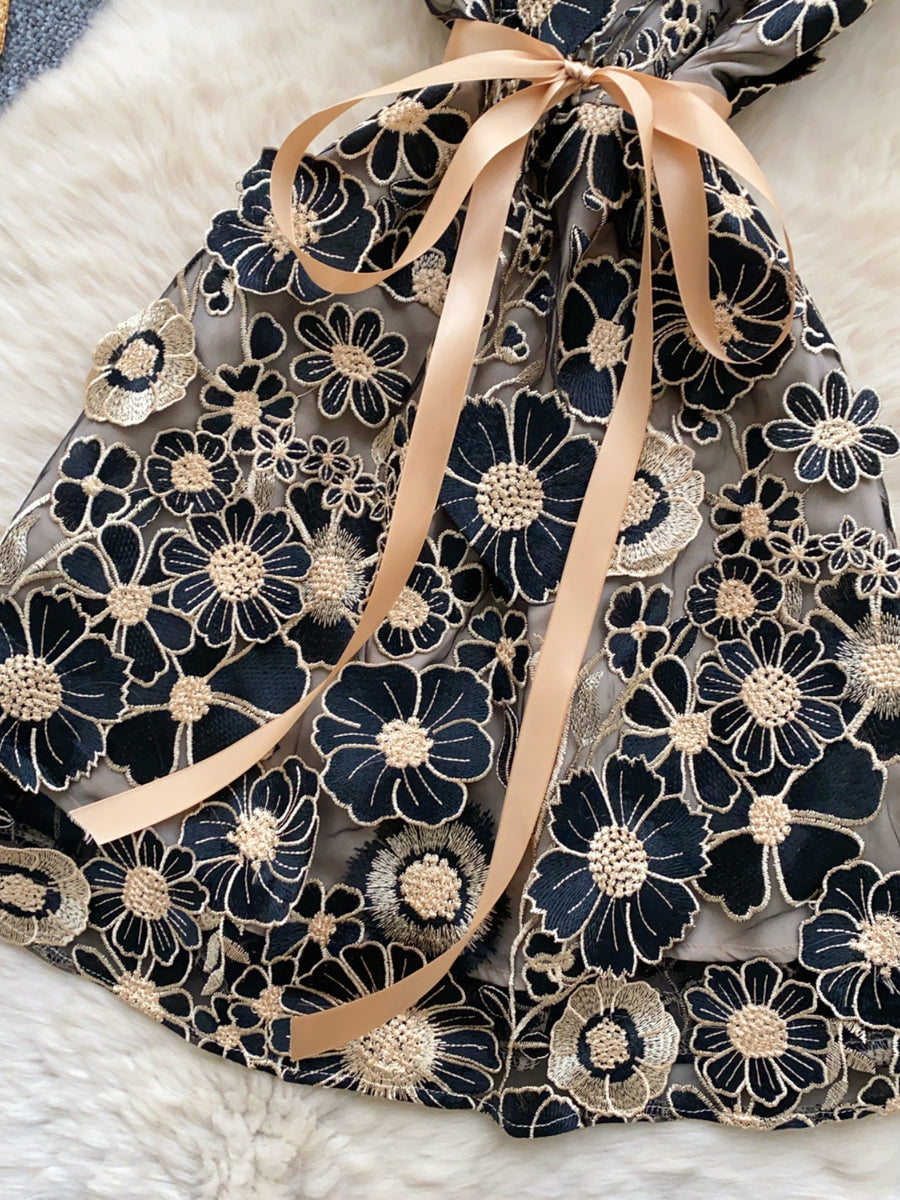 Embroidered floral mini dress in Black Gold with a bow detail.
