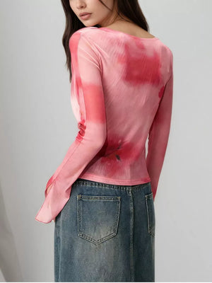 Pink watercolor tie-front t-shirt with flared sleeves and floral print detail.