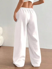 White wide-leg maternity joggers with elastic waistband and relaxed fit.