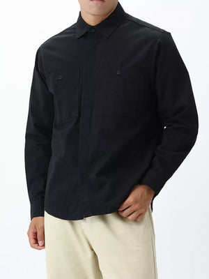 Men's black cotton button-down shirt with two chest pockets.