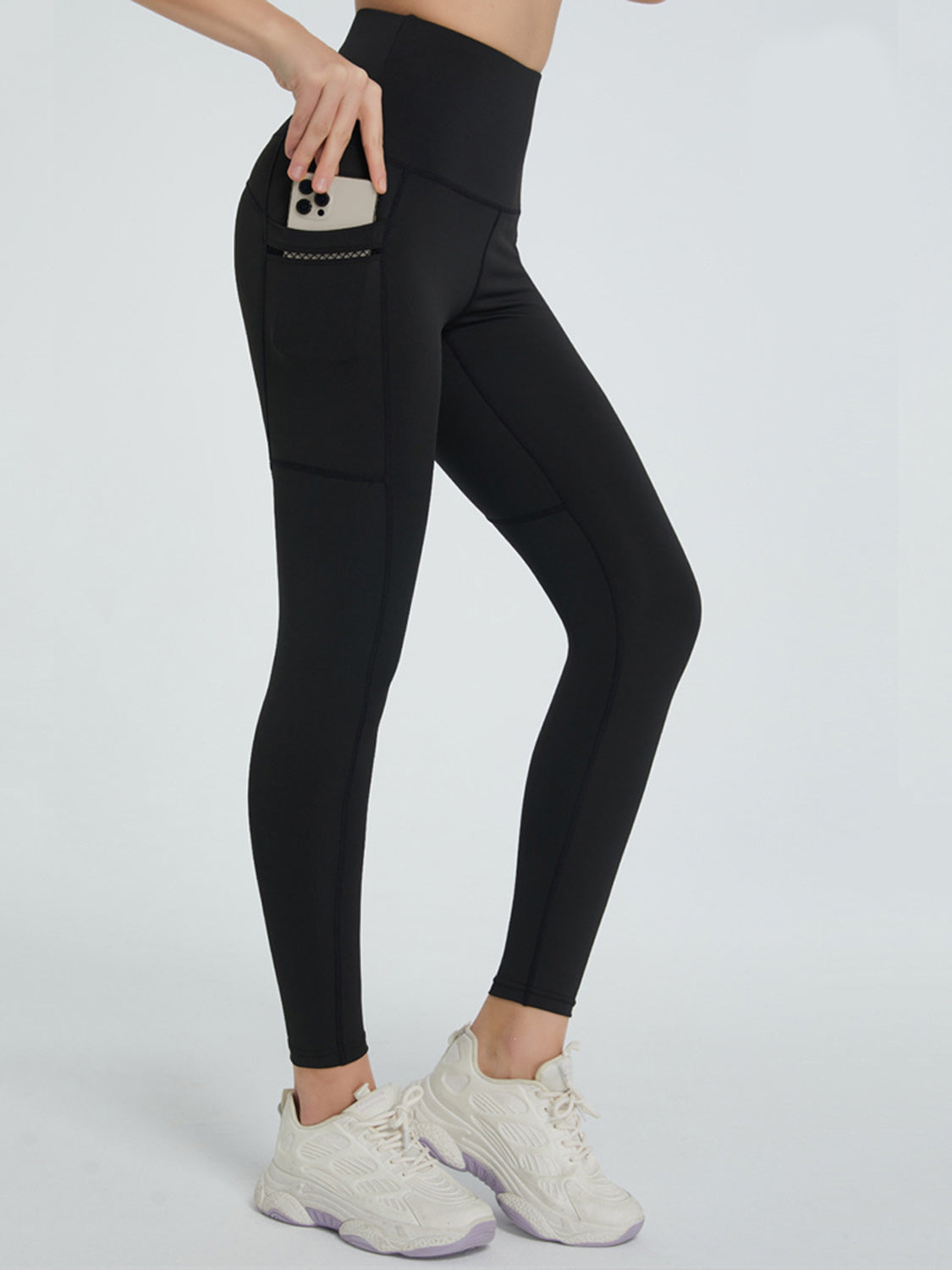 Black pocketed sculpt leggings with a phone in the side pocket.