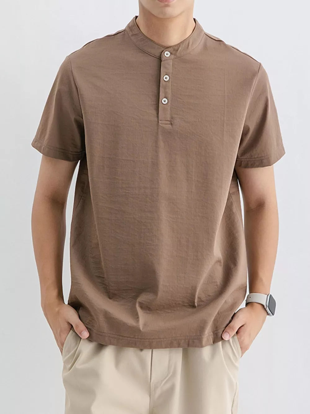 Brown cotton henley t-shirt with short sleeves and button placket.