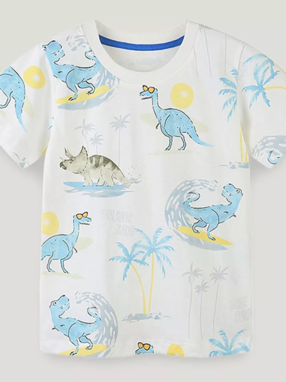 White toddler t-shirt with blue dinosaurs surfing and palm trees.