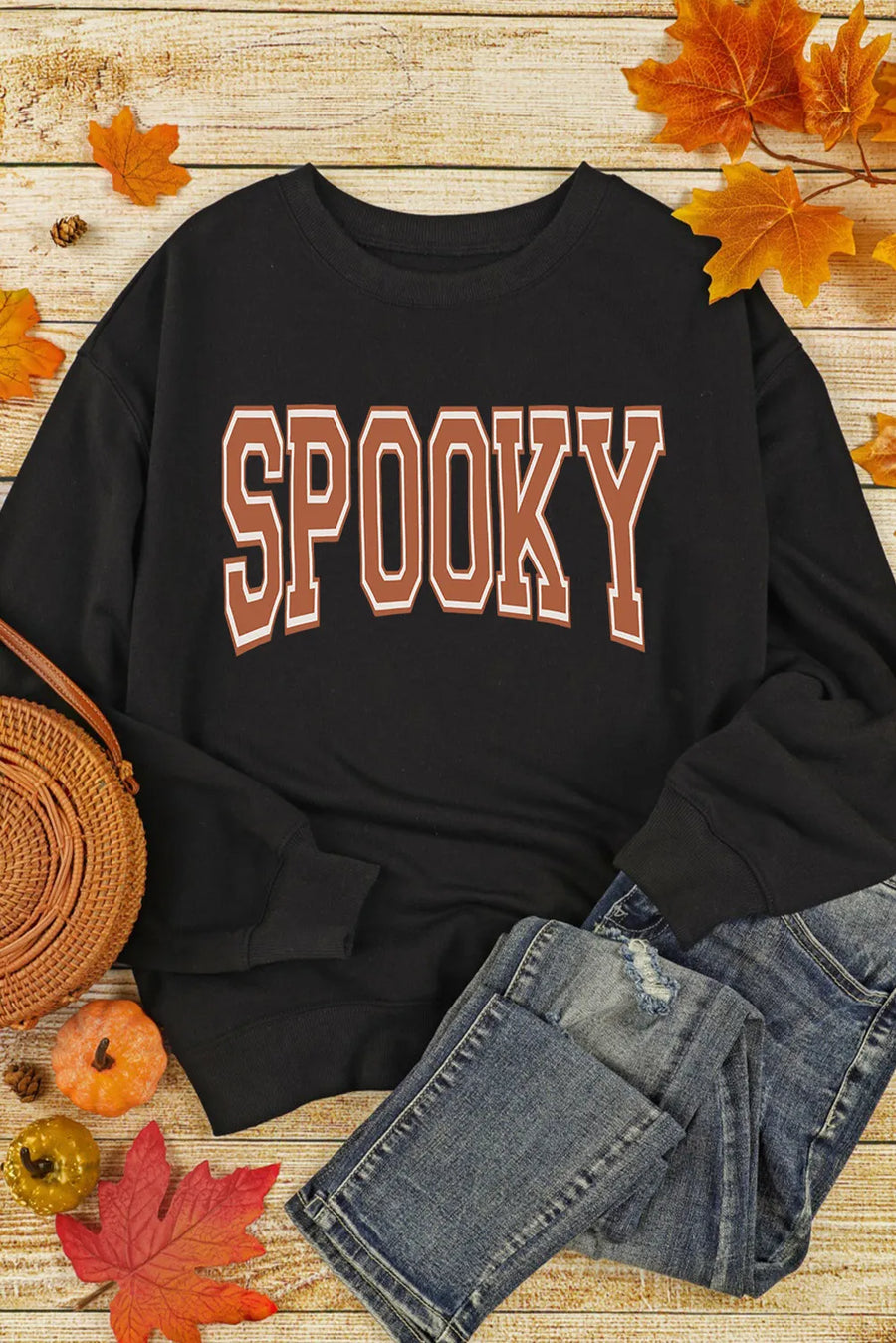 Black sweatshirt with "SPOOKY" graphic in brown and white varsity lettering.