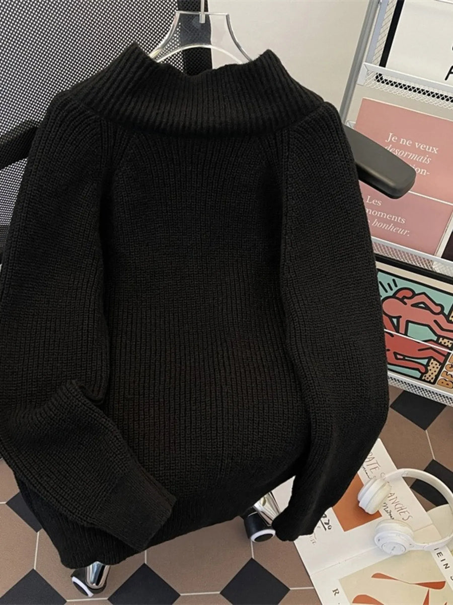 Black ribbed zip-up cardigan with a mock neck, long sleeves, and a relaxed fit.