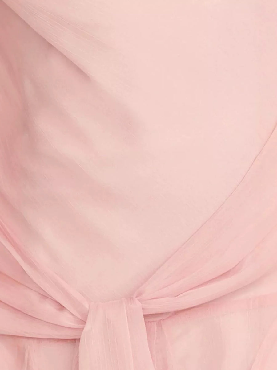 Pink maxi dress with draped knot detail and subtle vertical texture.