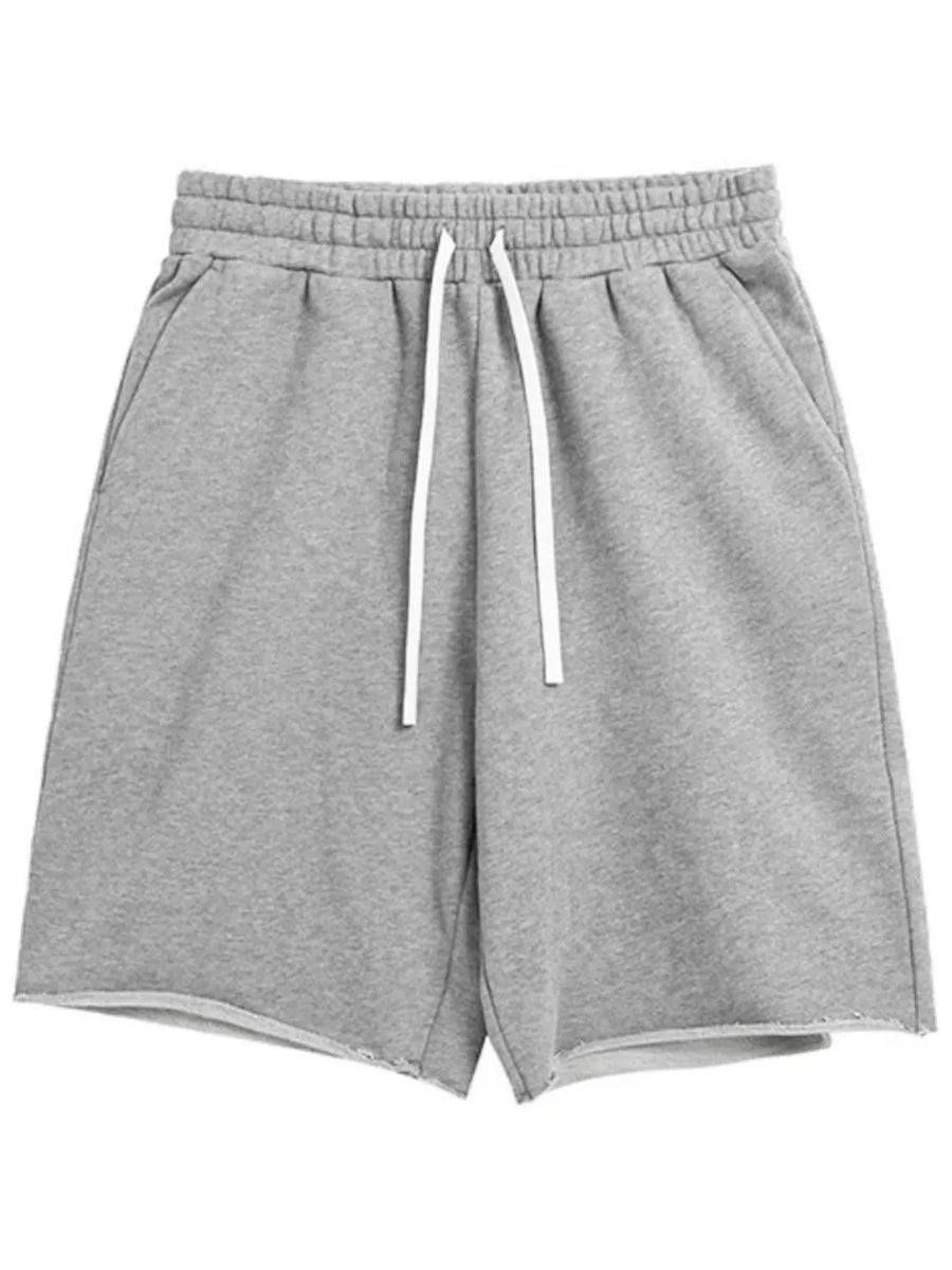 Gray relaxed fit jogger shorts with raw edge hem and white drawstring.