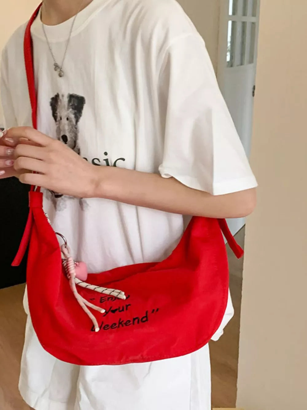 shoulder bag in red featuring adjustable straps and relaxed fit