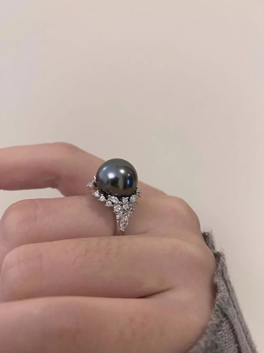 Luminous gray pearl and silver ring with diamond accents.