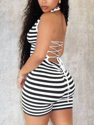 Black and white striped romper with crisscross backless detail and halter neck.