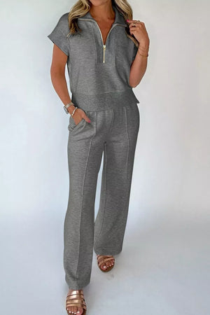 Dark gray half-zip polo shirt and wide-leg pants set with gold zipper detail.