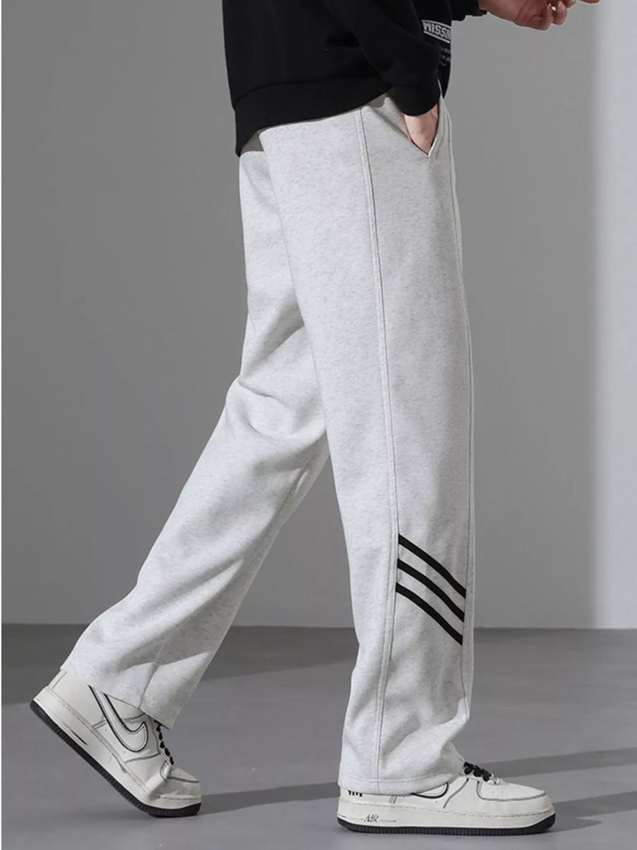 Light Flower Gray sweatpants with black side stripes and a loose fit.