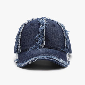 Distressed denim baseball cap with frayed edges in dark blue.