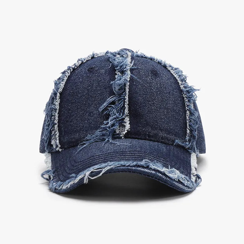 Distressed denim baseball cap with frayed edges in dark blue.