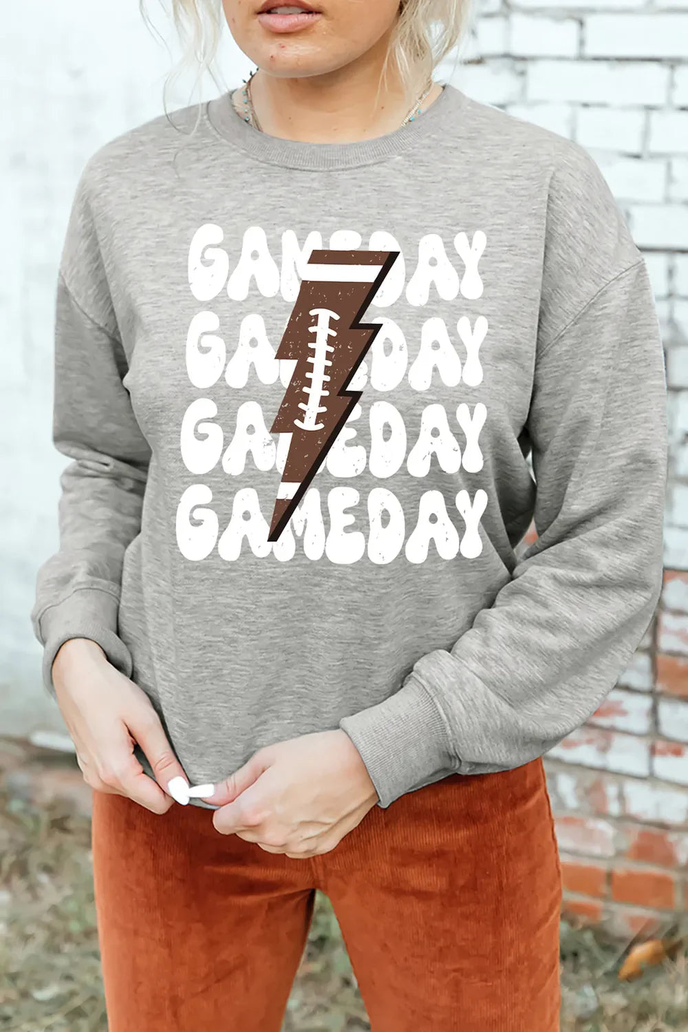 Gray sweatshirt with retro football lightning bolt graphic and "Gameday" text.