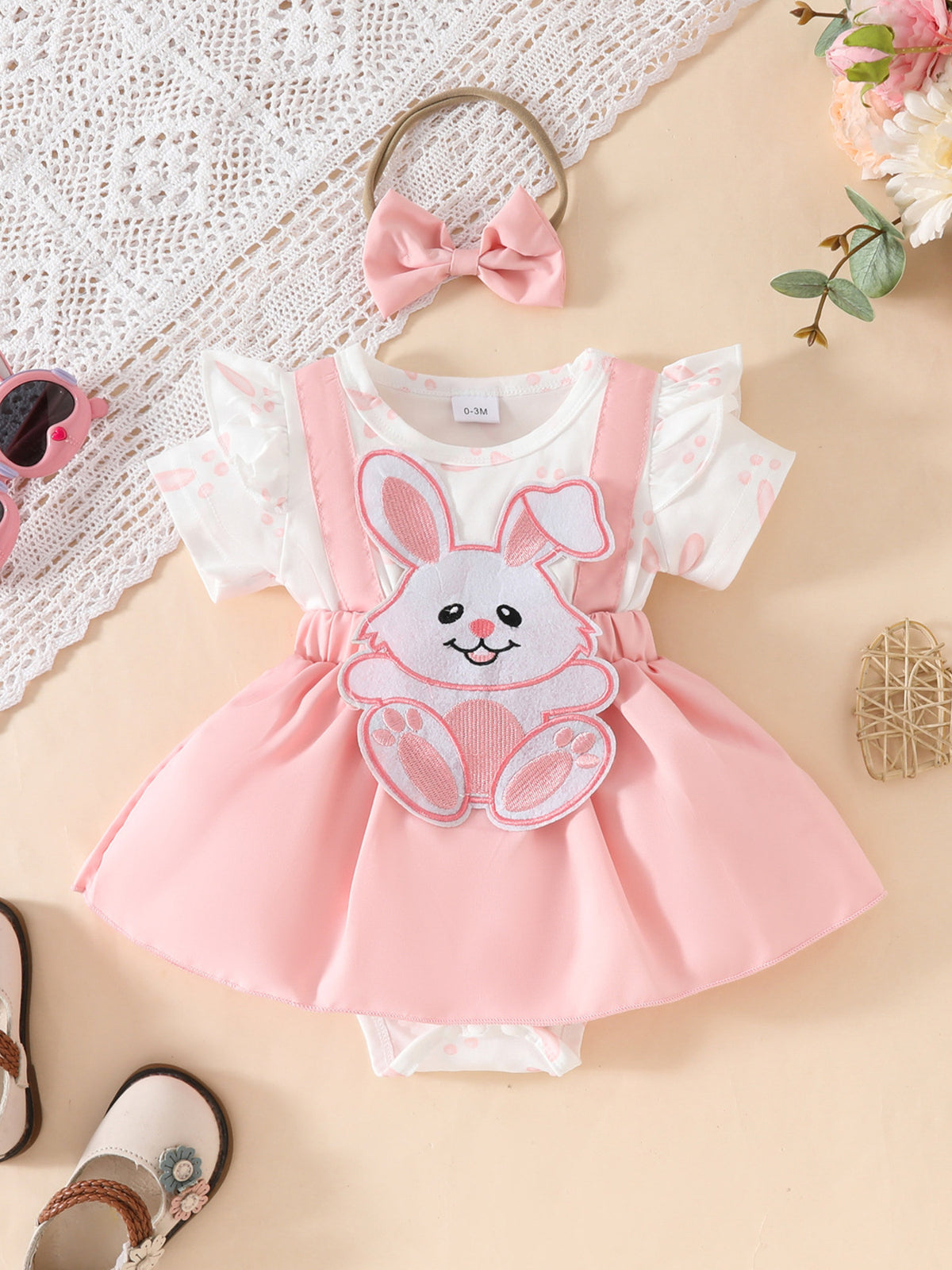 Pink baby dress set with bunny applique and matching headband.