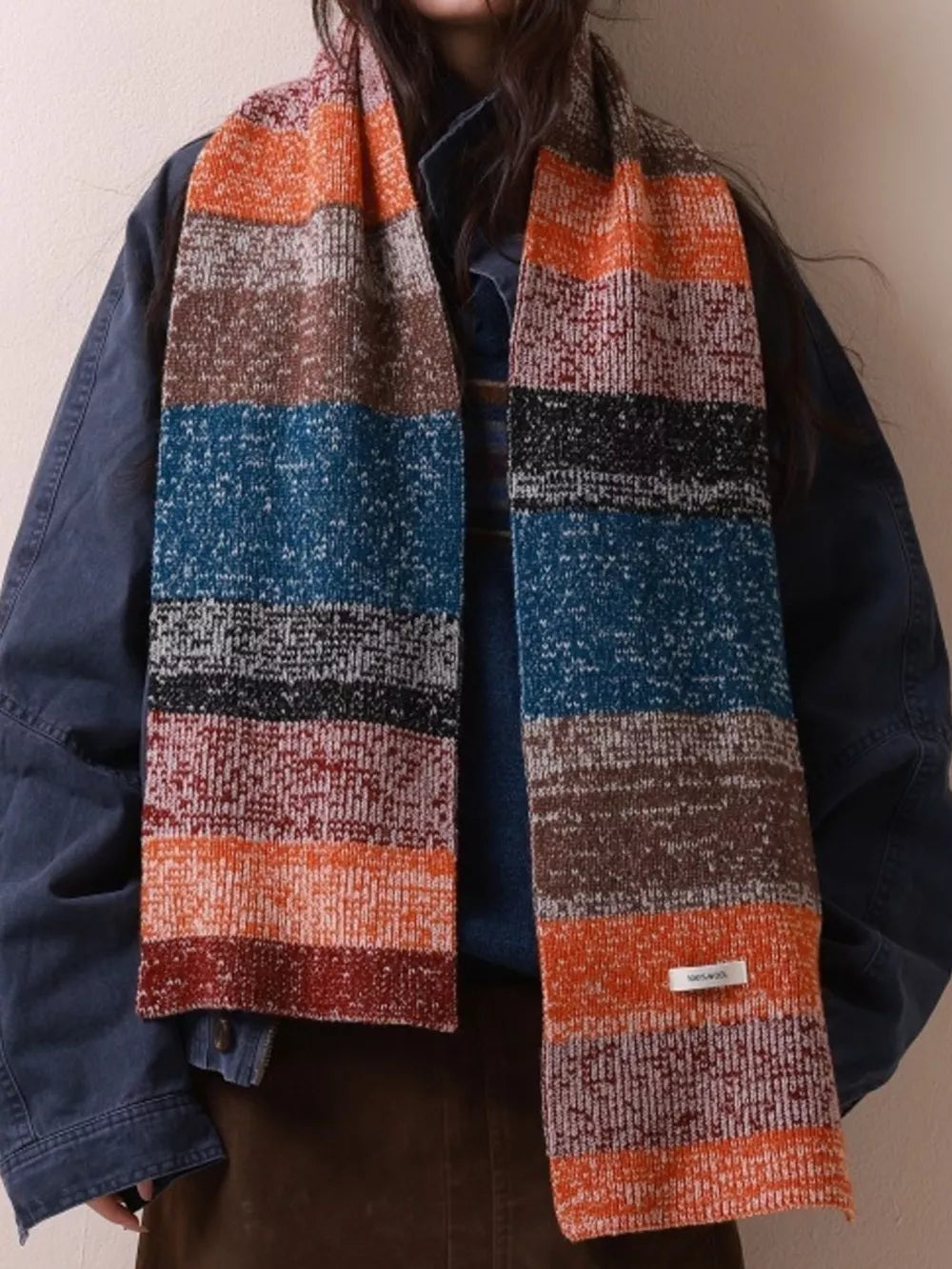 Textured wool scarf with color block stripes in orange, brown, blue, and red.