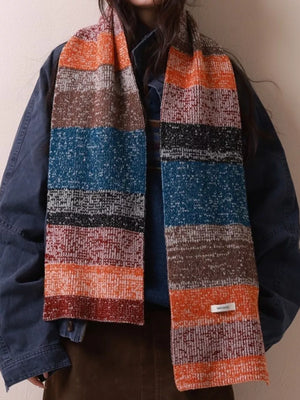 Textured wool scarf with color block stripes in orange, brown, blue, and red.
