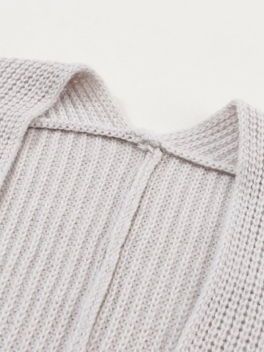 Light gray acrylic knit cardigan showing neckline detail and ribbed texture.